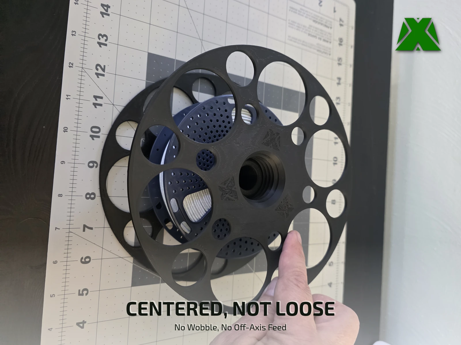 The adapter face on with a navy 250 g spool nested inside it, visible through the openings in the flange