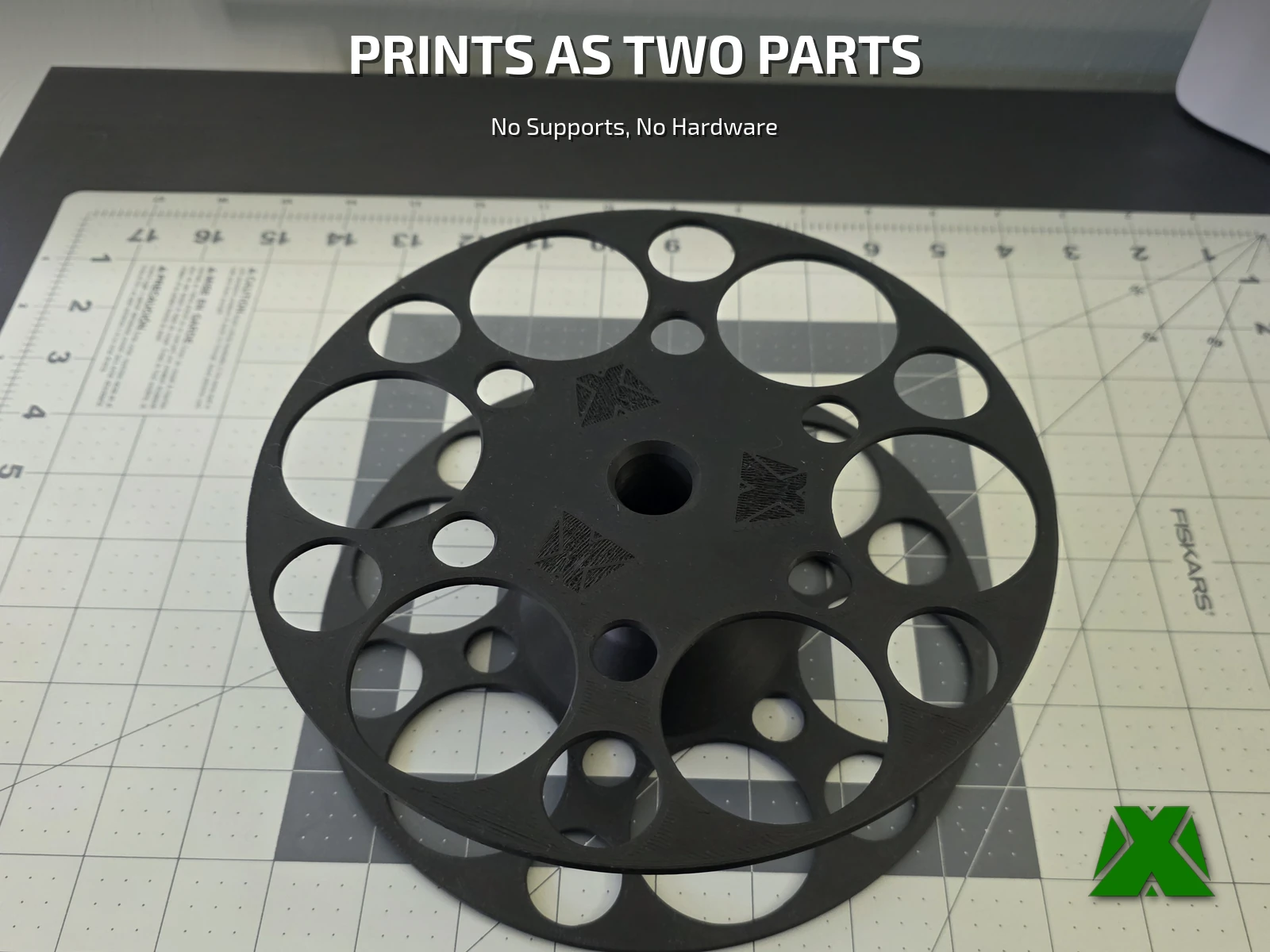 The assembled adapter lying face up on a cutting mat, its spoked flange and threaded center bore in view