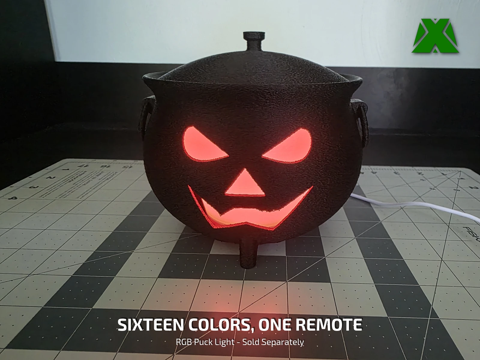 The cauldron lit red with the lid on, sitting closed on a cutting mat