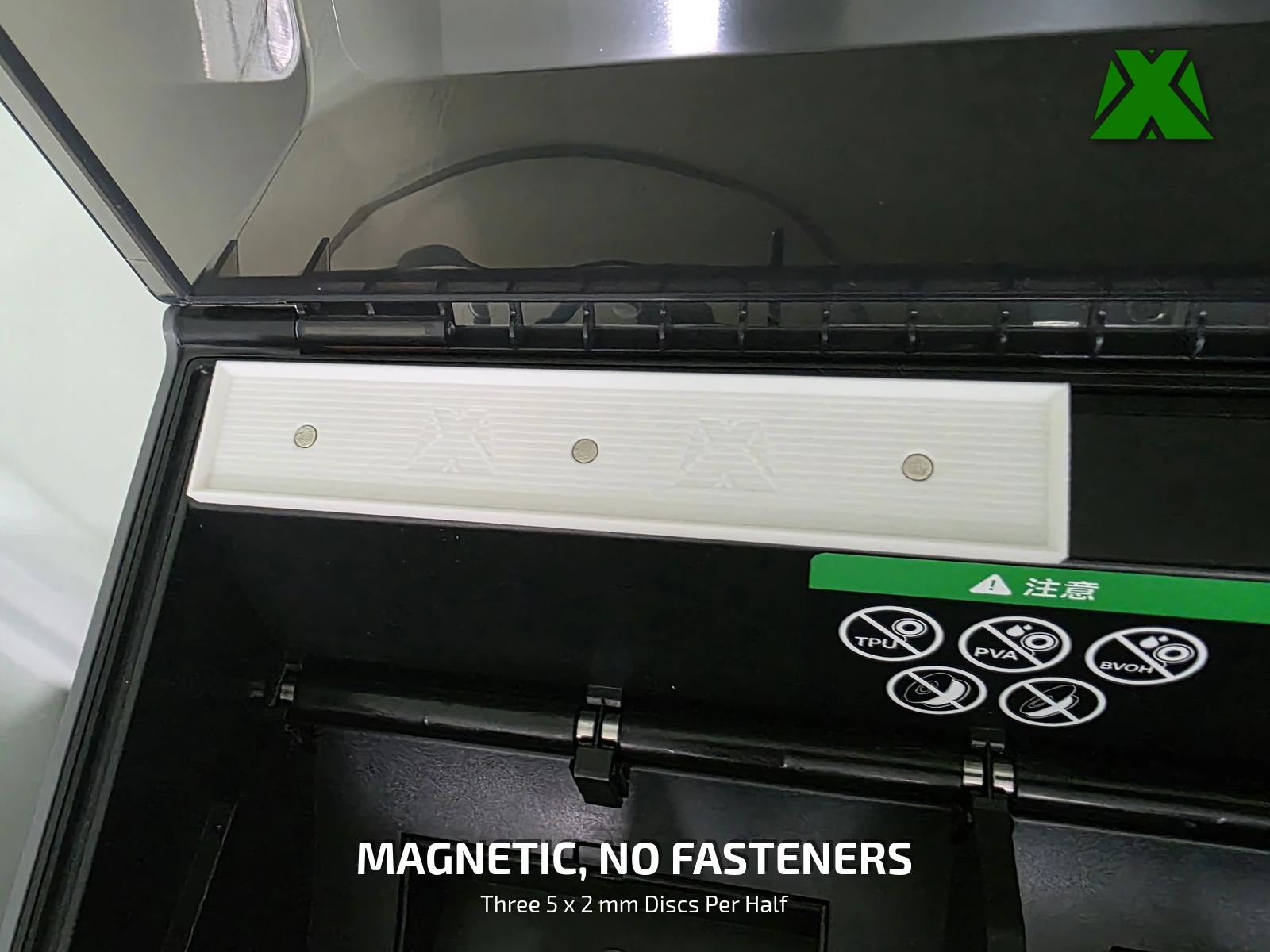 A tray lifting off its base rail inside the CFS, held only by magnets