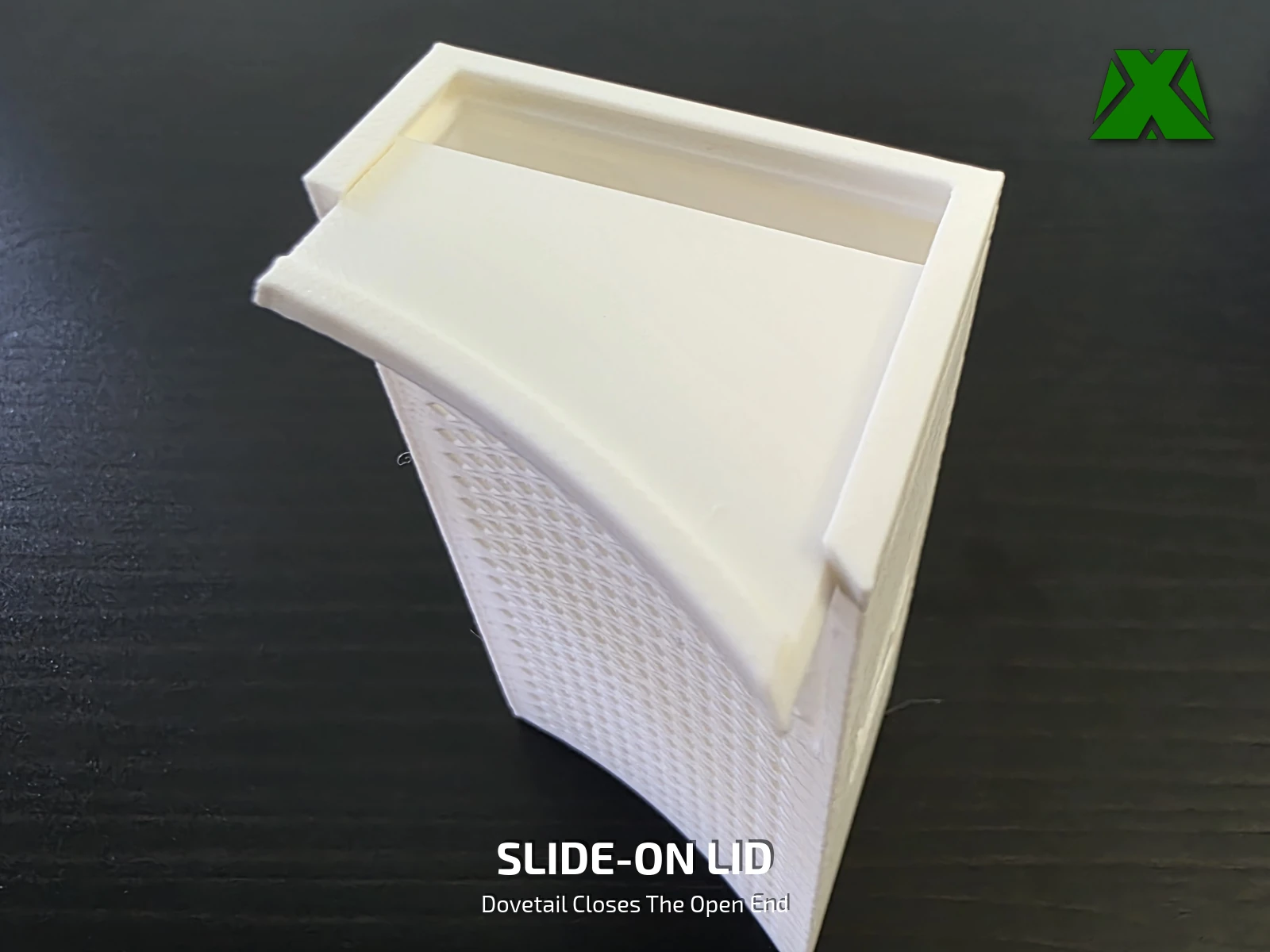 The solid lid sliding into the dovetail across the open end of a tray standing on end