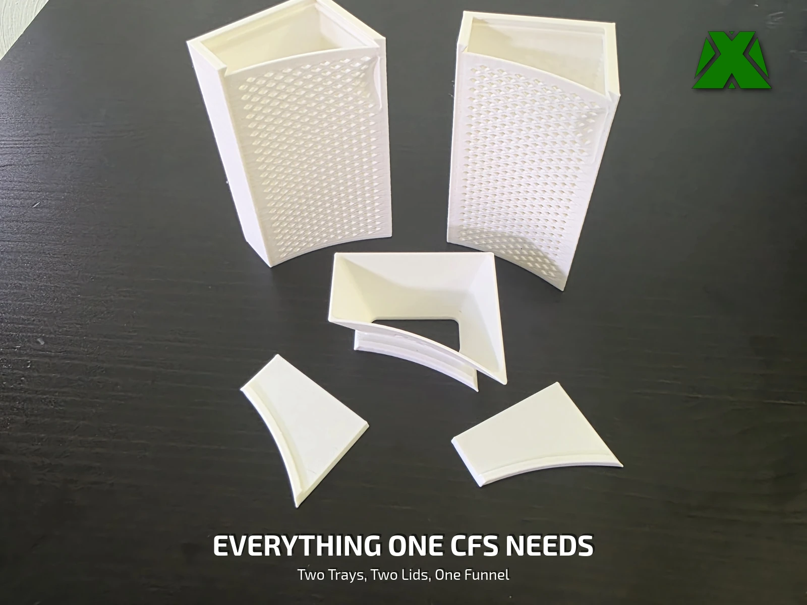 The printed parts laid out on a desk: two trays, two solid lids and one funnel lid