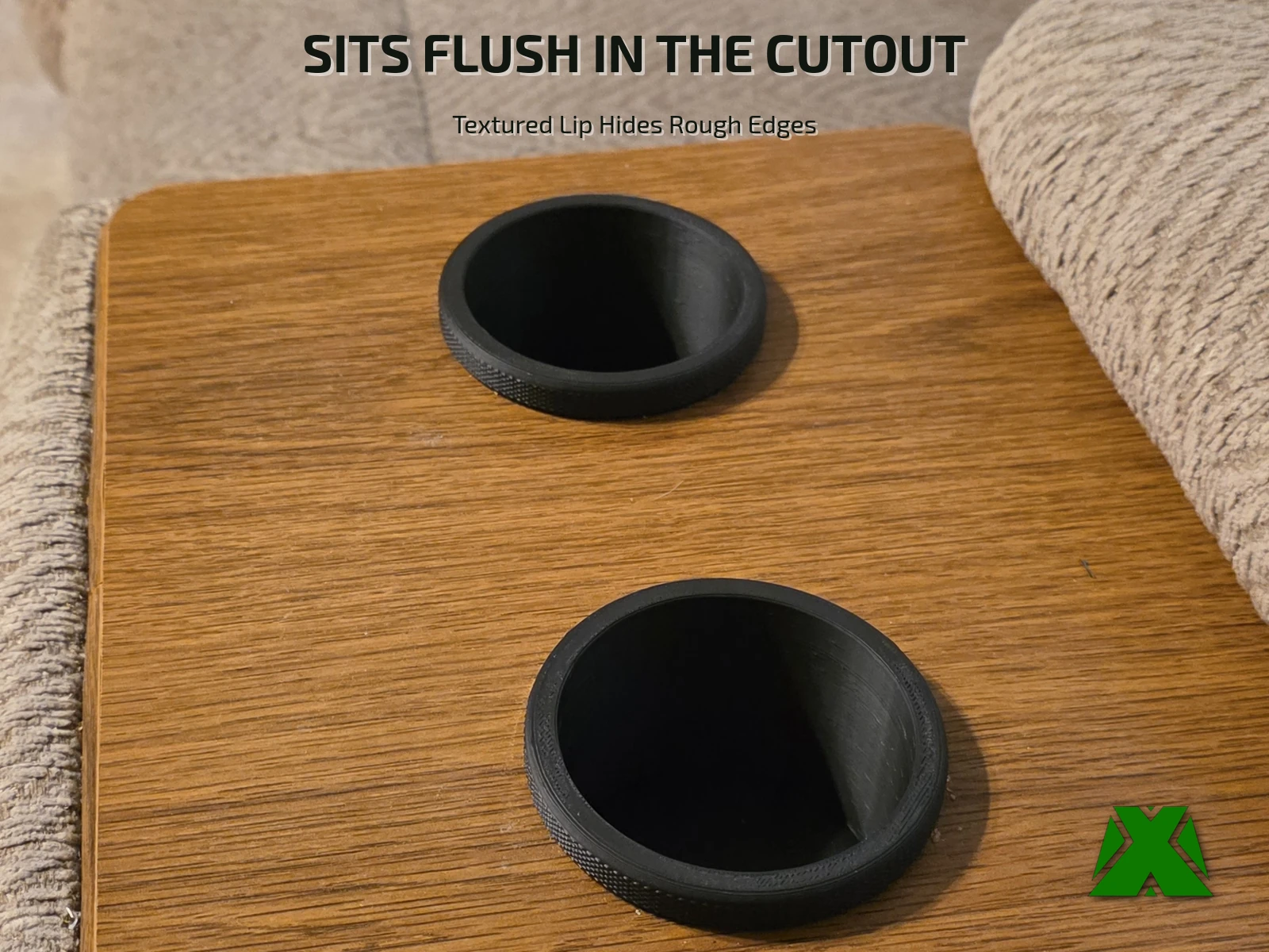 Two printed cup holders seated flush in the wooden cutouts of a couch arm table
