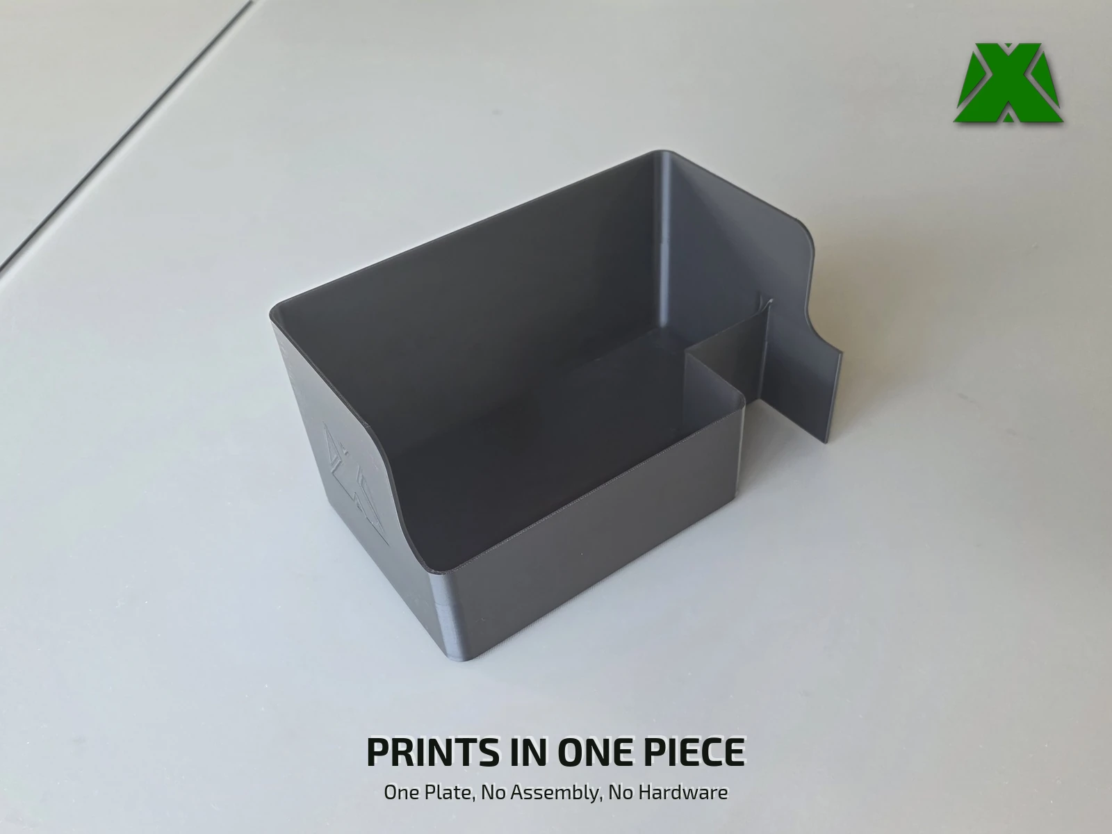 The empty bin on a desk, showing it is a single printed shell with no seams or fasteners