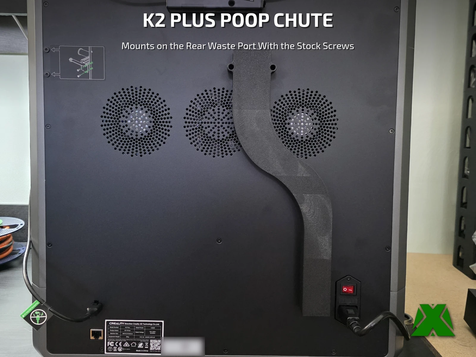 The black poop chute installed on the back panel of a Creality K2 Plus, curving down between the rear fans to end beside the power inlet