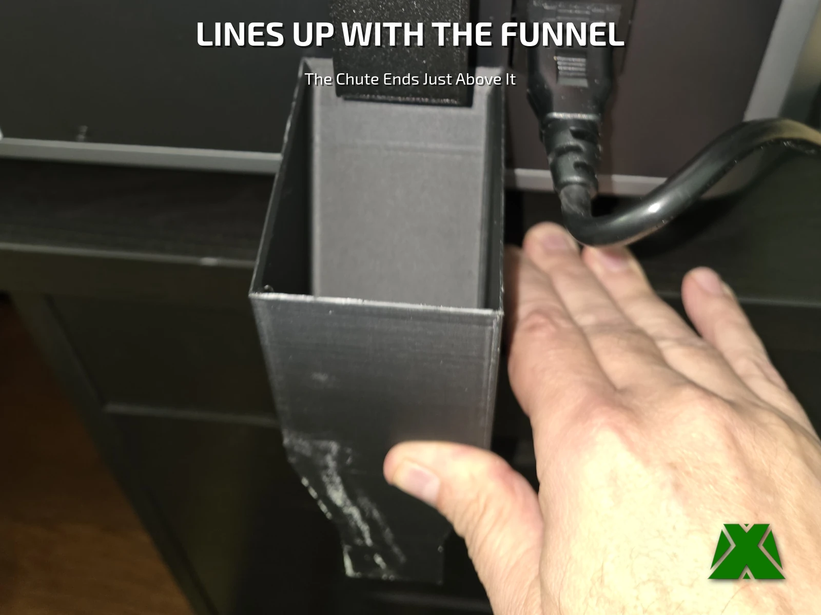 Looking down into the top of the desk funnel, with the end of the chute just above it