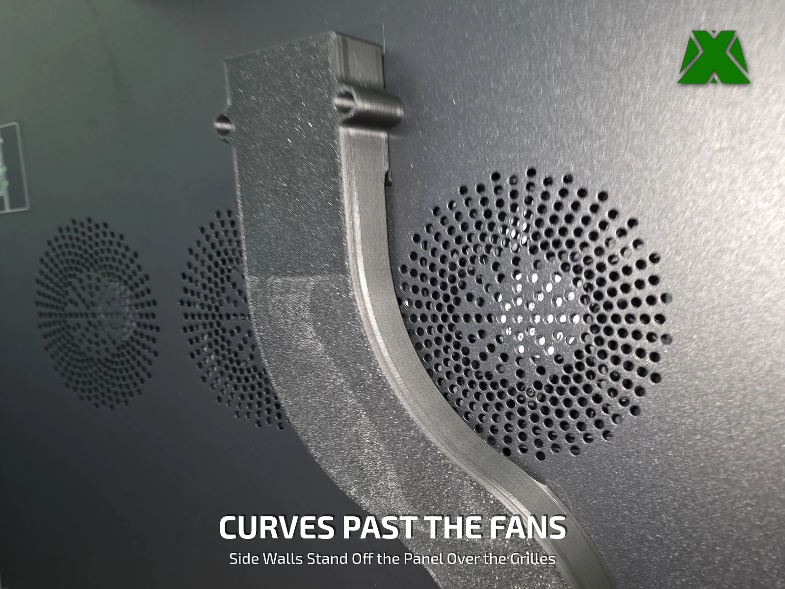 Close-up of the top of the chute held to the back panel by two tabs, curving down past a fan grille
