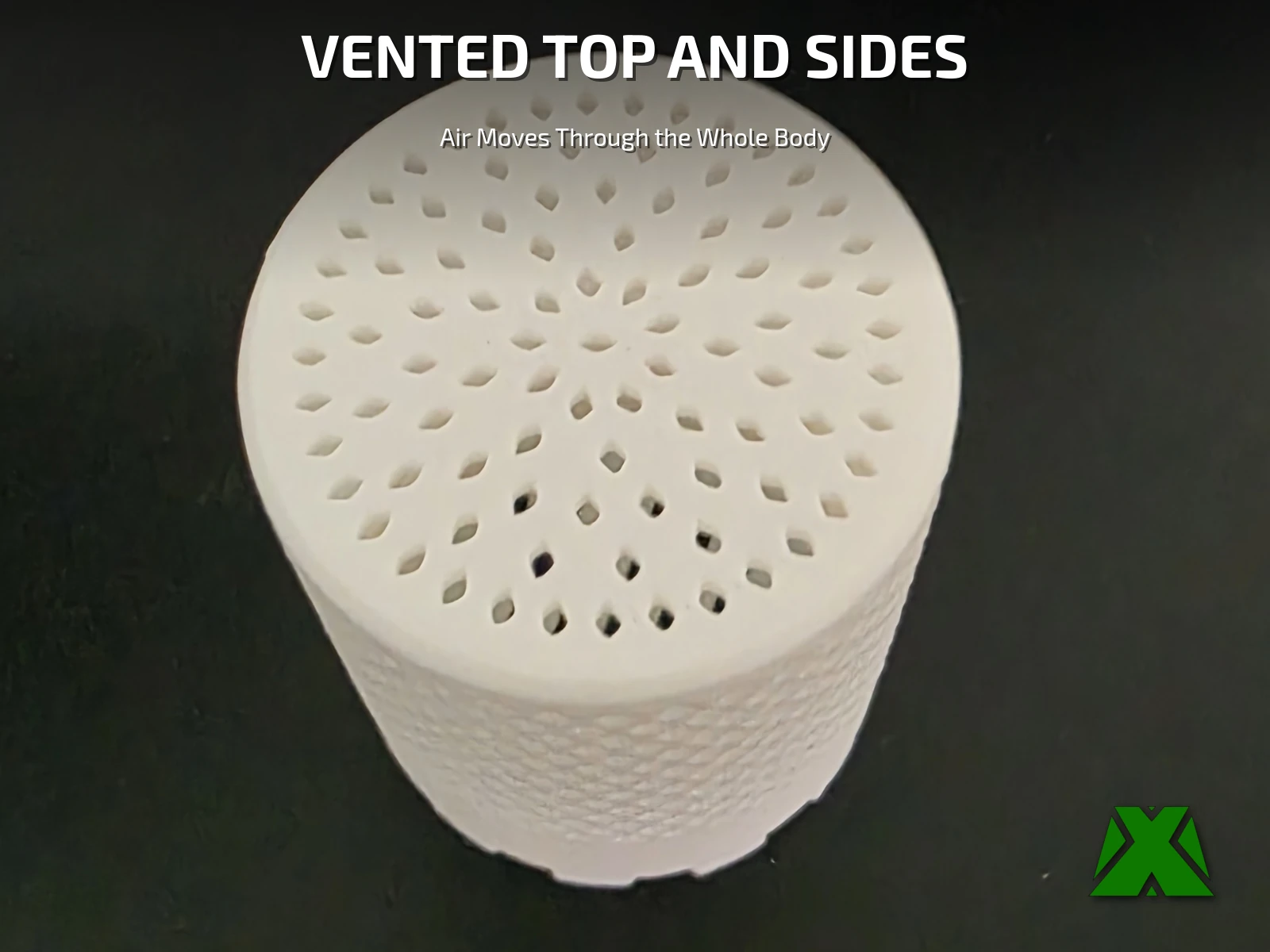 The assembled container from above, its lid pierced by rings of teardrop-shaped vents over the full face