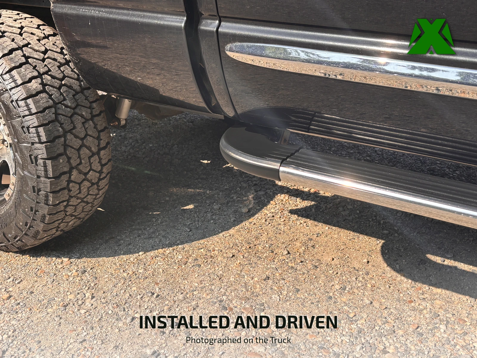 The truck's front wheel and rocker panel with the finished cap in place on the running board, seen from a few feet back