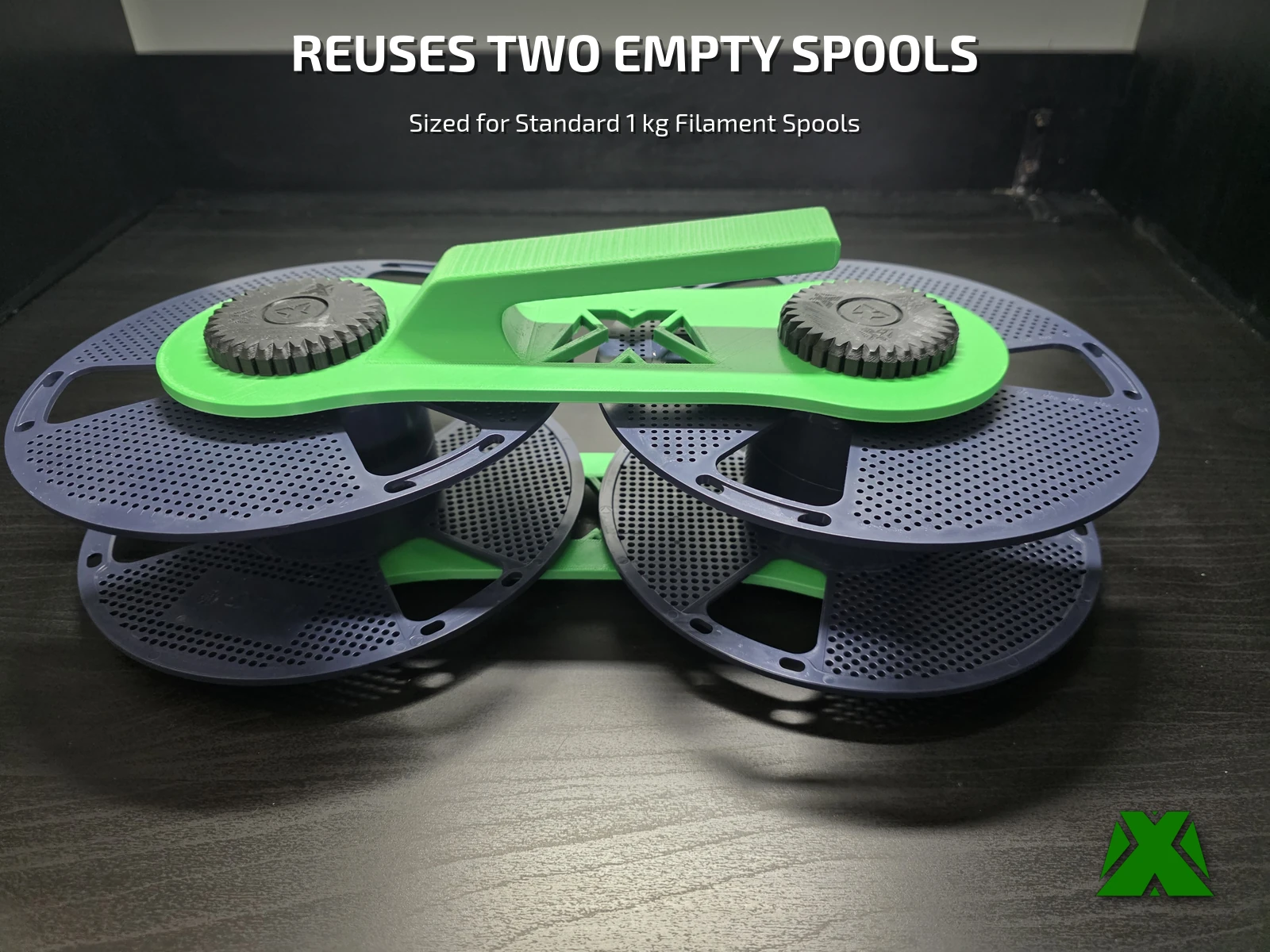 The assembled spooler with no cord: two navy spools clamped side by side between a green base plate and handle plate