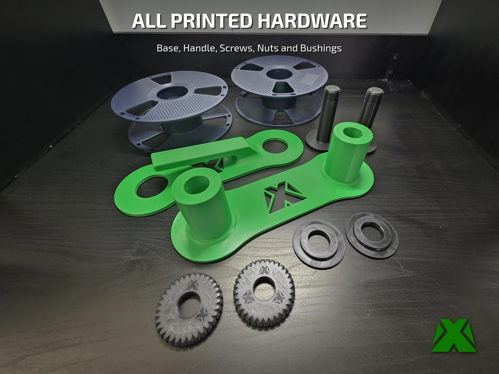 The green base plate and handle plate, two black screws, two knurled nuts and two bushings laid out beside two empty navy spools