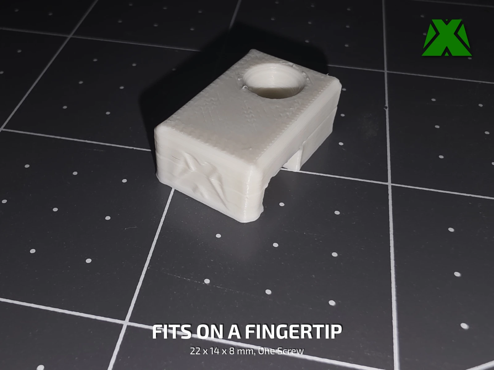 A single clip on the build plate, showing the countersunk screw hole and the open cord channel underneath