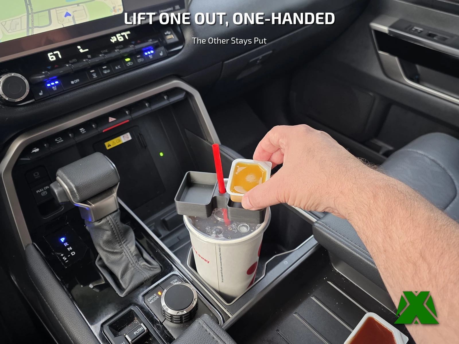A hand lifting one sauce cup out of the holder while the second stays seated on the drink