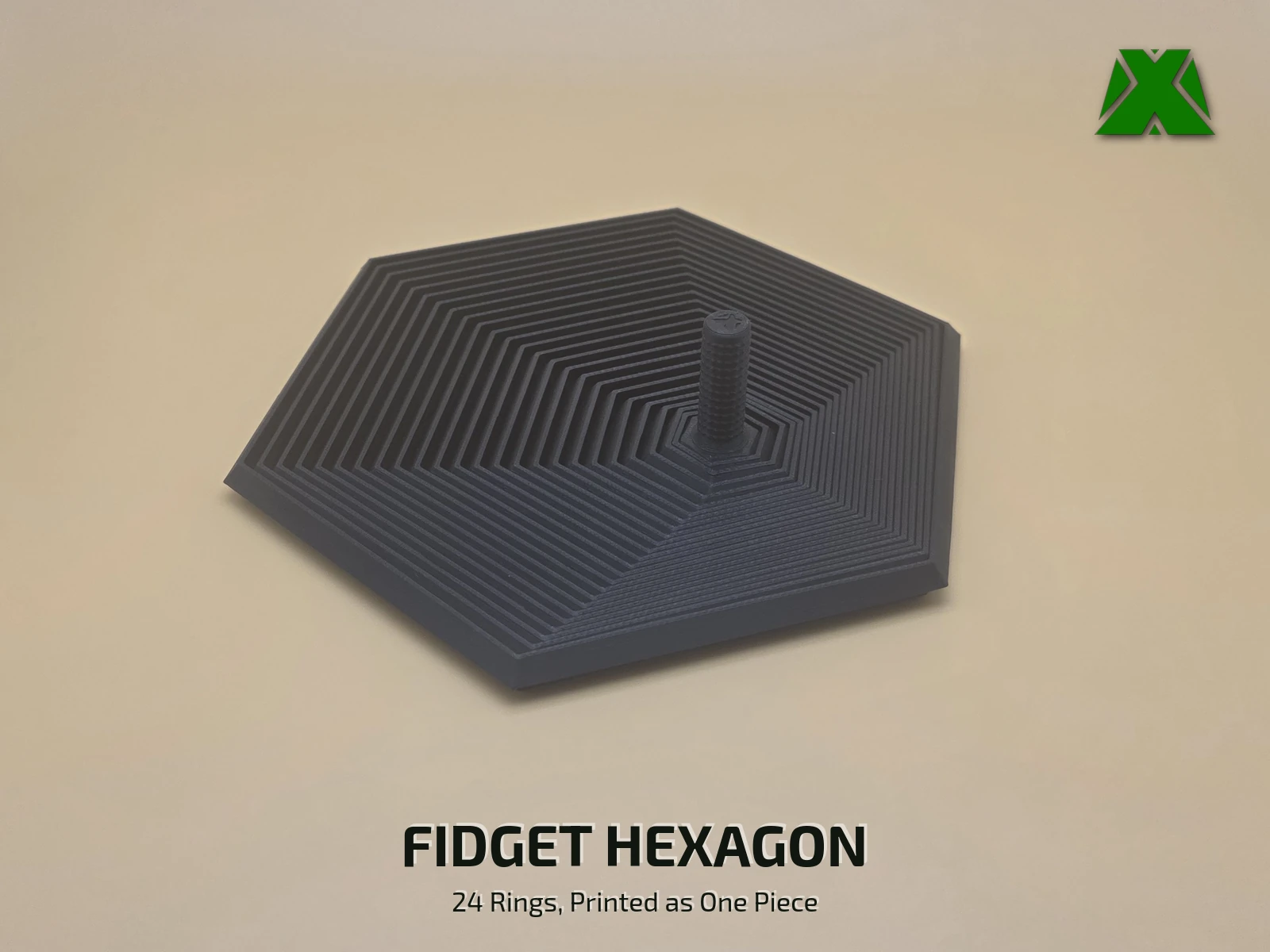 A black print-in-place fidget hexagon lying flat on a tan backdrop, its 24 nested six-sided rings stepping out from a short textured stem