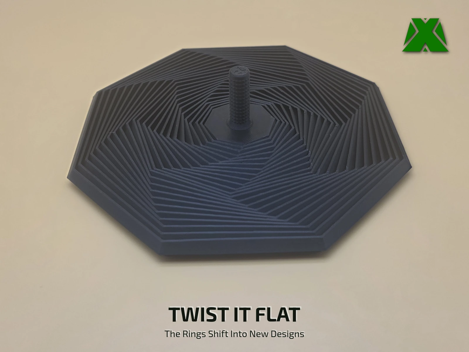 The fidget octagon twisted flat on the desk, its 23 rings swept around out of line into an eight-armed pinwheel