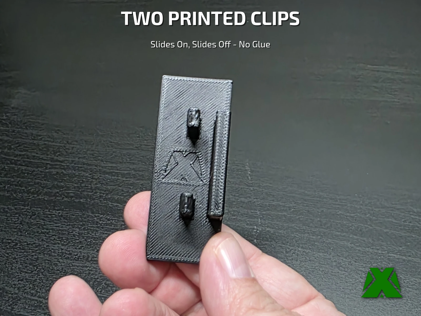 The back of the label showing its two printed clips and the embossed MakerX X