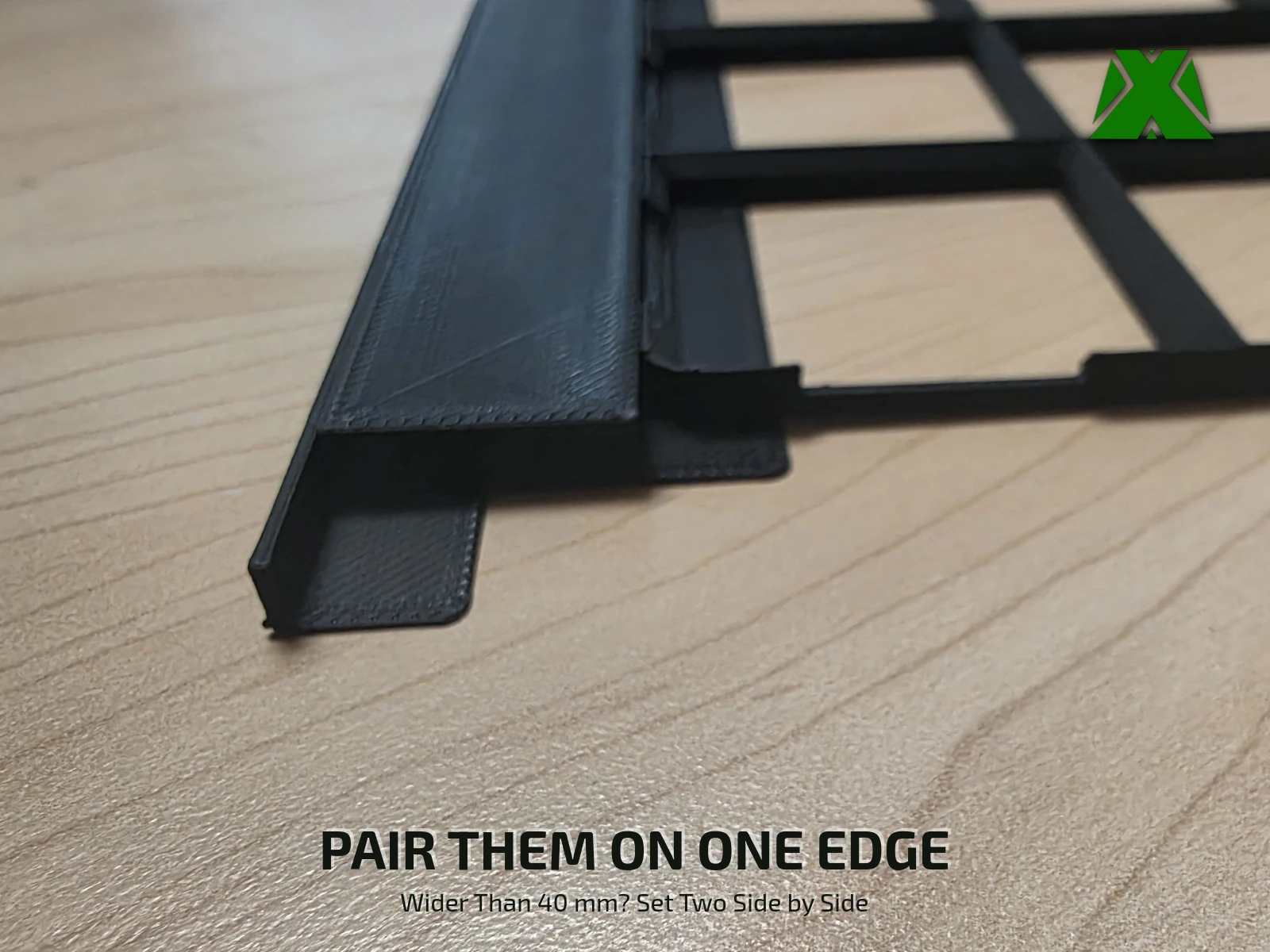 Two spacers set side by side along one edge of a baseplate to fill a gap wider than 40 mm