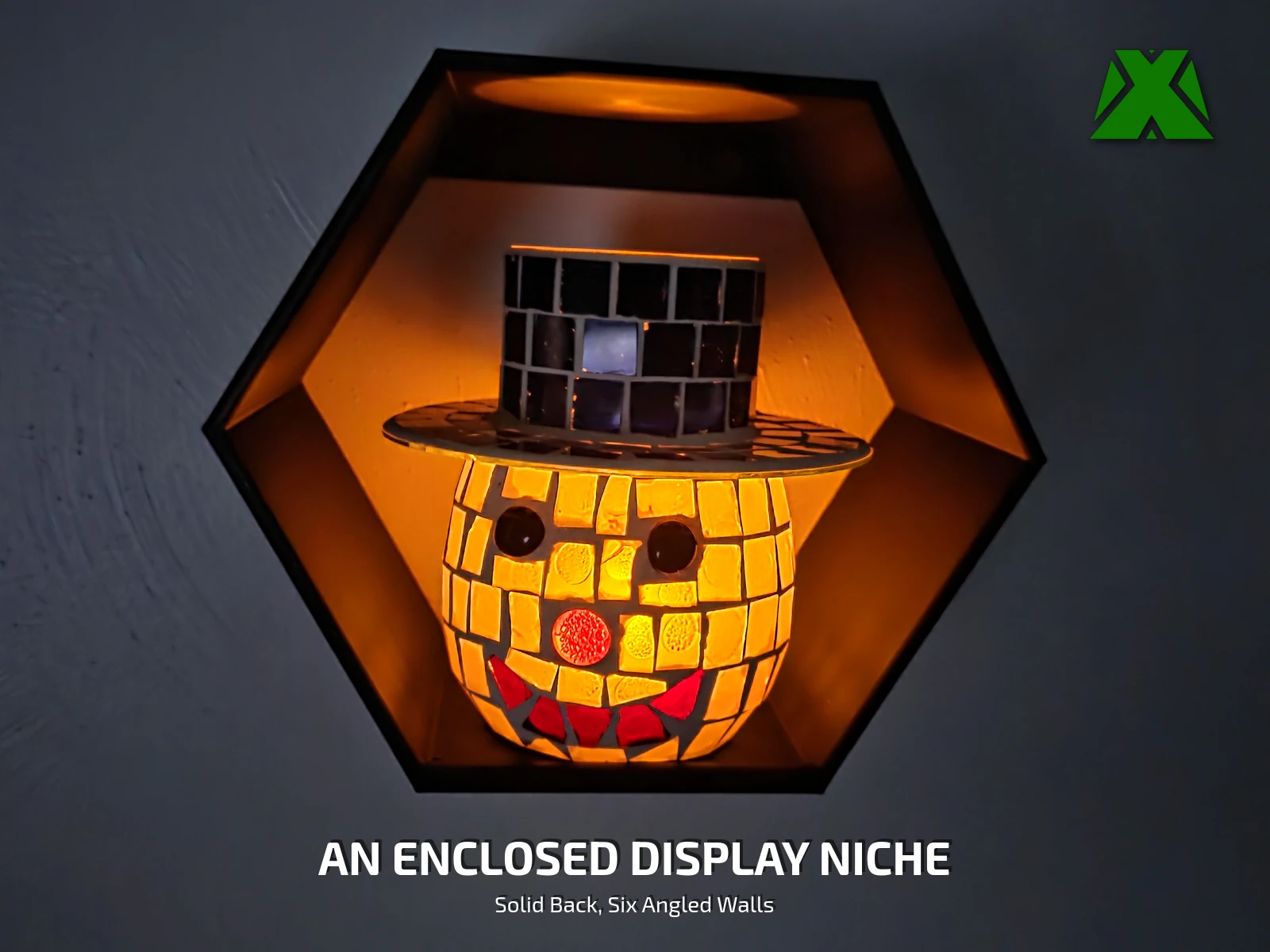 The shelf at night with a lit candle holder inside it, the glow picking out the six angled interior facets