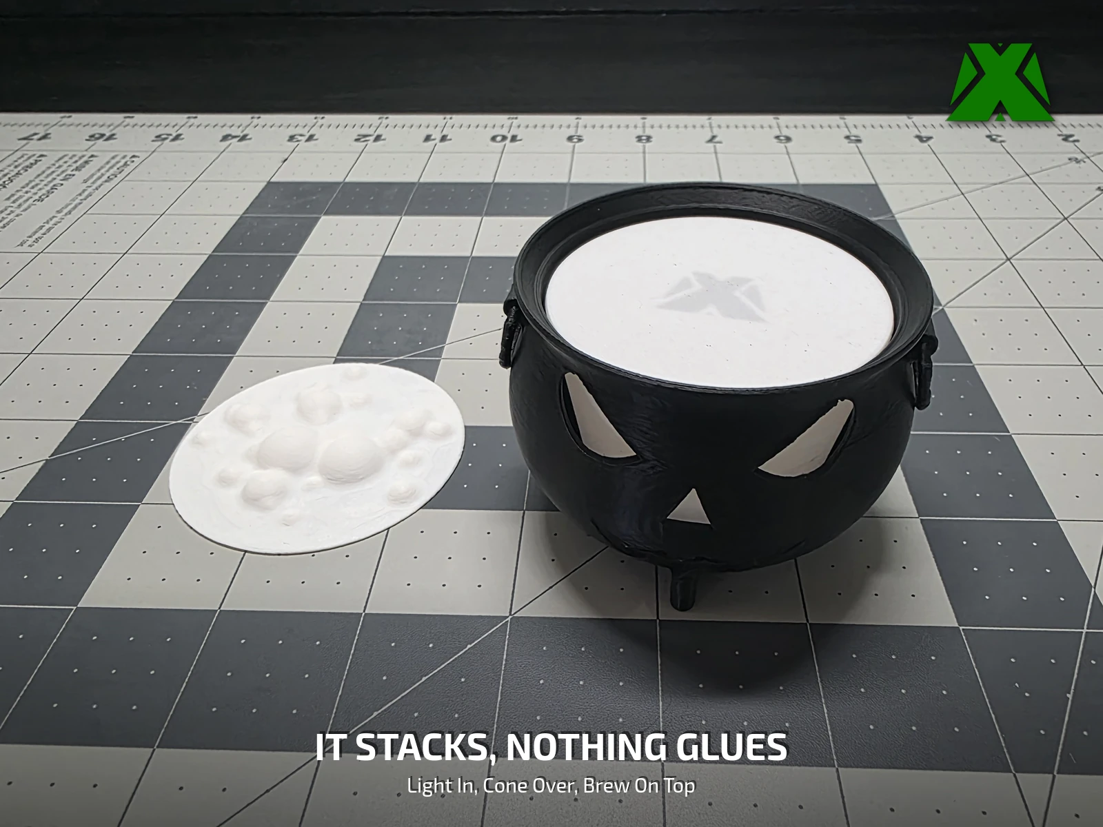 The cauldron unlit with the bubbling brew disc resting in its mouth, showing how the parts stack