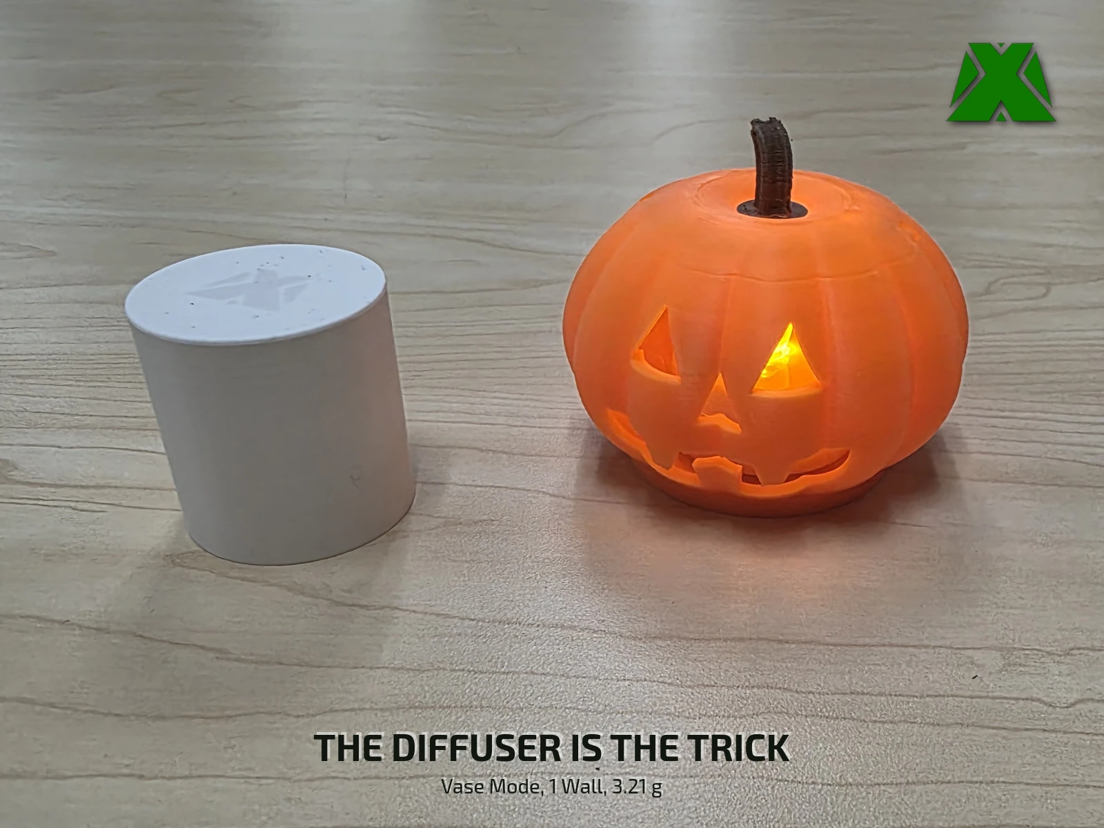 The lit lantern beside the white vase-mode diffuser that stands next to it, showing the part responsible for the even glow