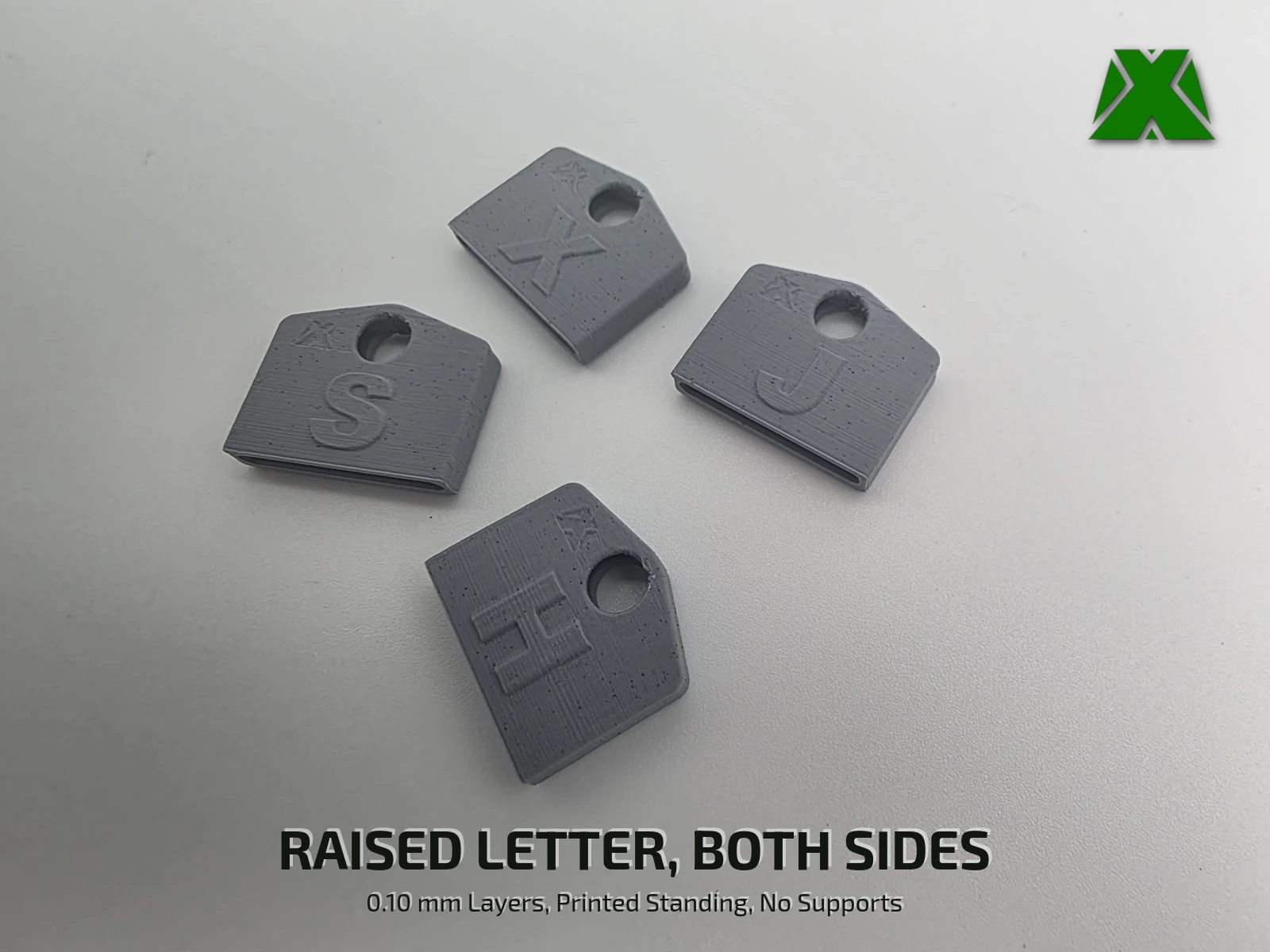 The same four covers on a light gray surface, showing the raised letters and the open key slot along the bottom edge