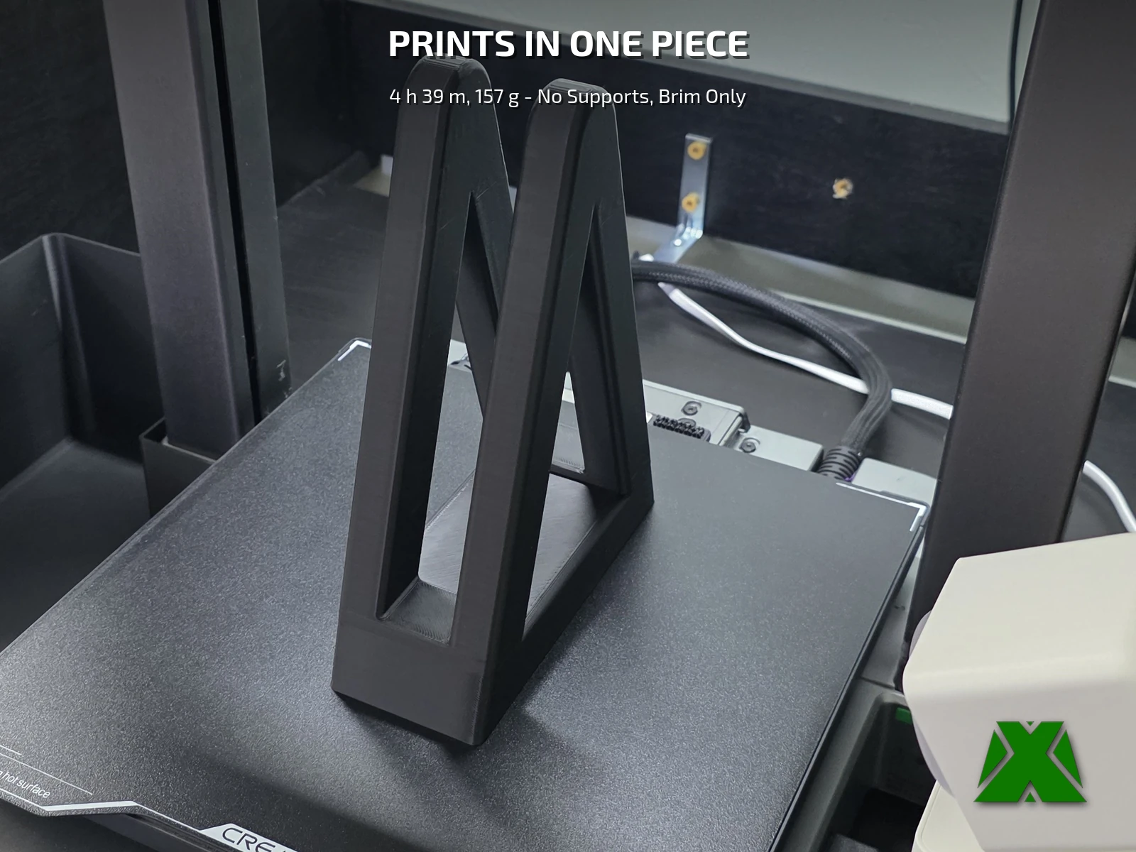 The stand printed upright on the build plate with its brim still attached