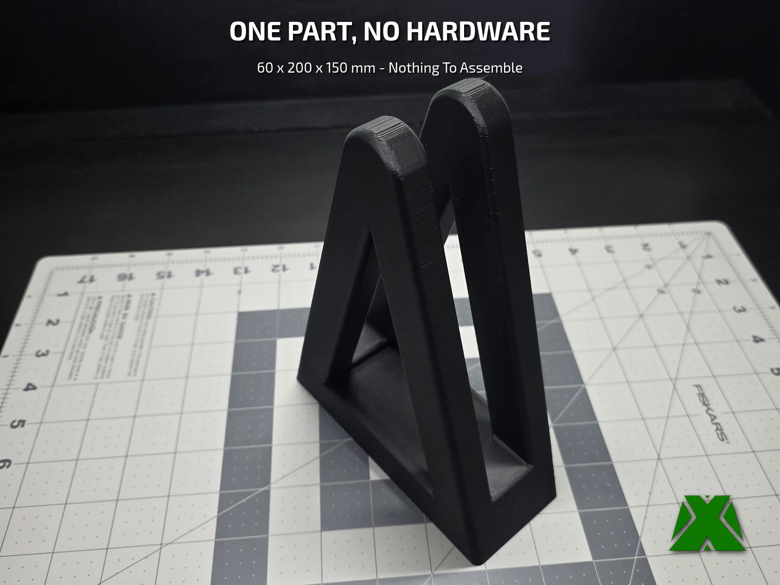 The printed vertical laptop stand alone on a cutting mat, a rule along the mat edge showing its size