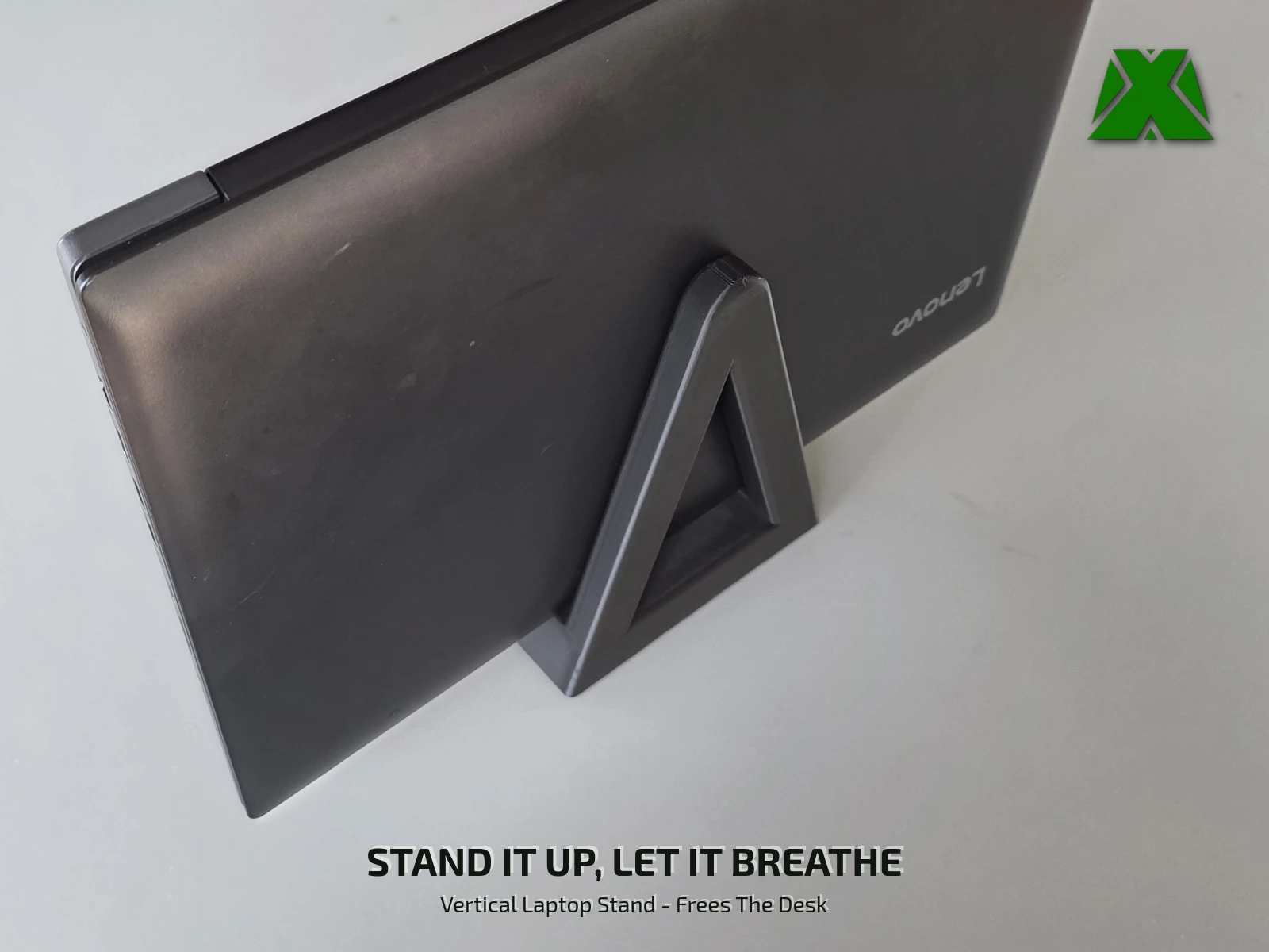 A closed laptop standing on edge in the printed stand on a desk