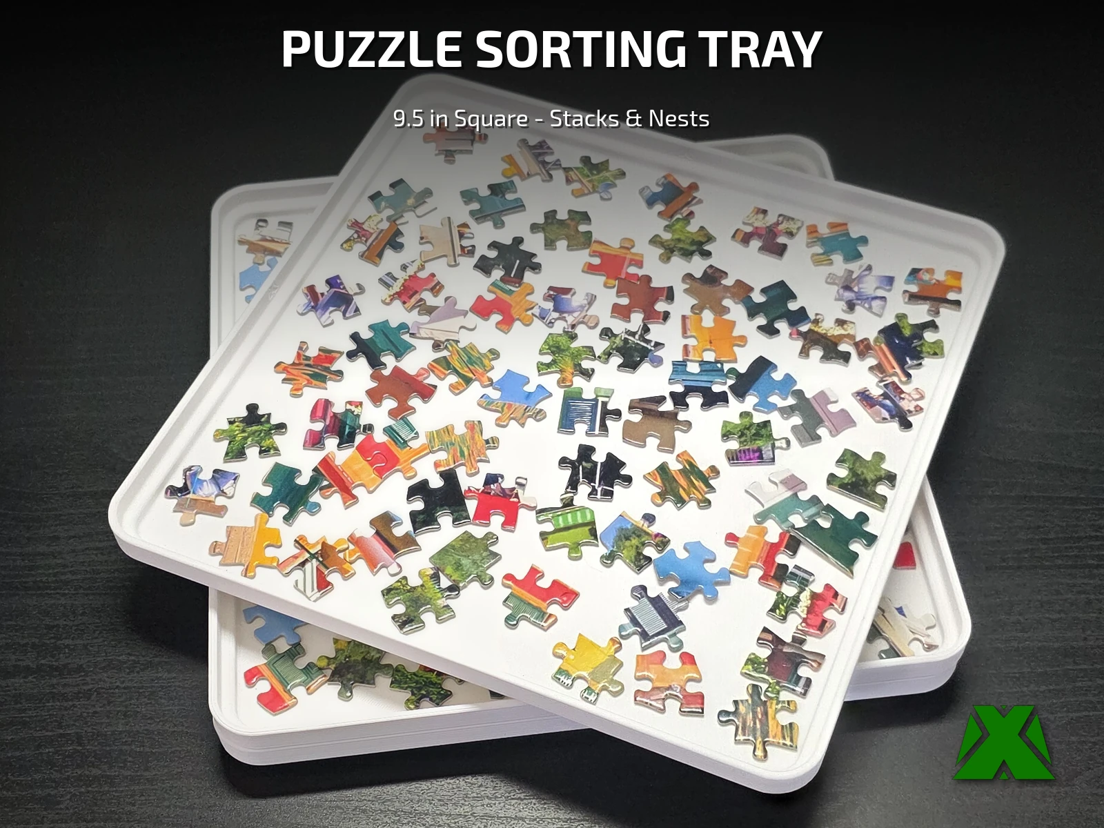 Two stacked puzzle trays printed in white, the top one holding loose puzzle pieces spread out for sorting