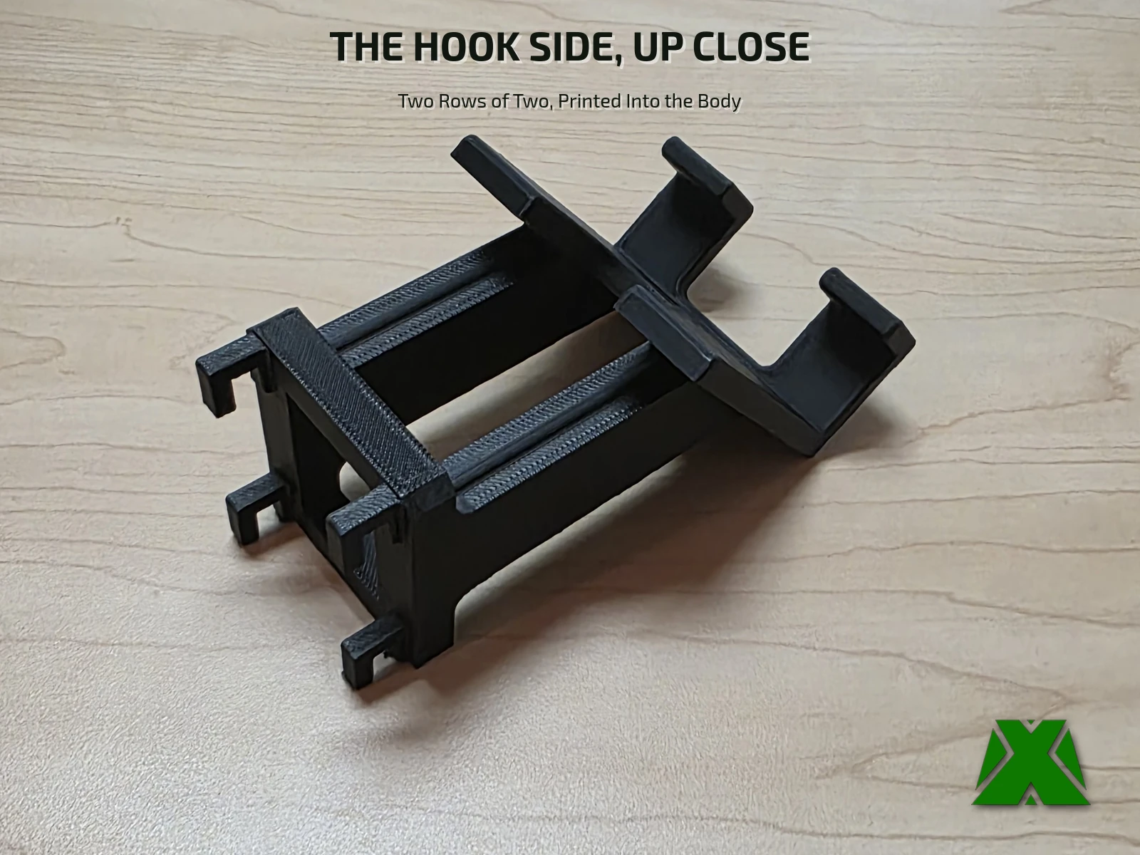 The back of the mount stood on a desk, showing all four printed hooks in silhouette