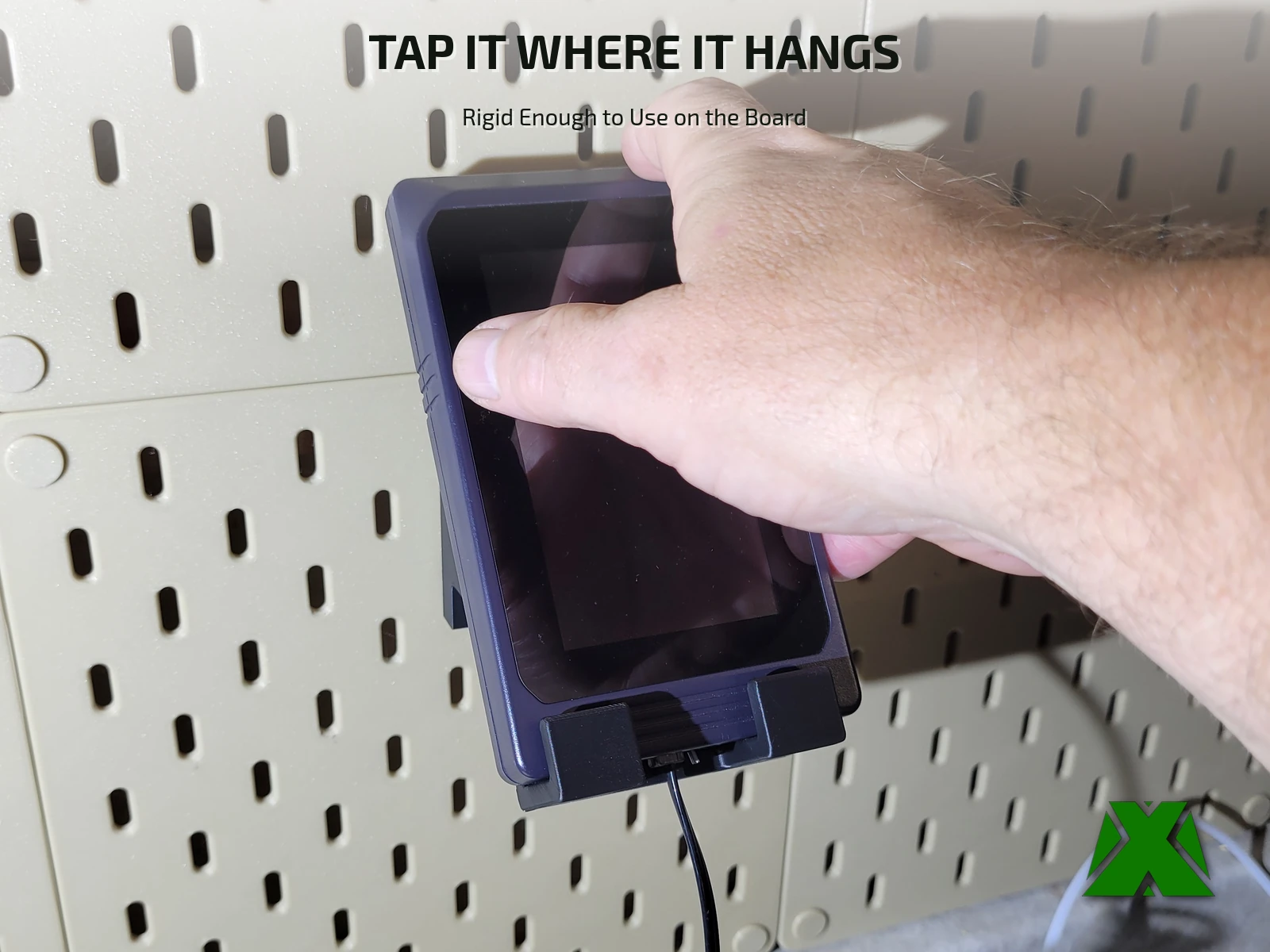 A finger tapping the controller's touchscreen while it hangs in the mount on the board