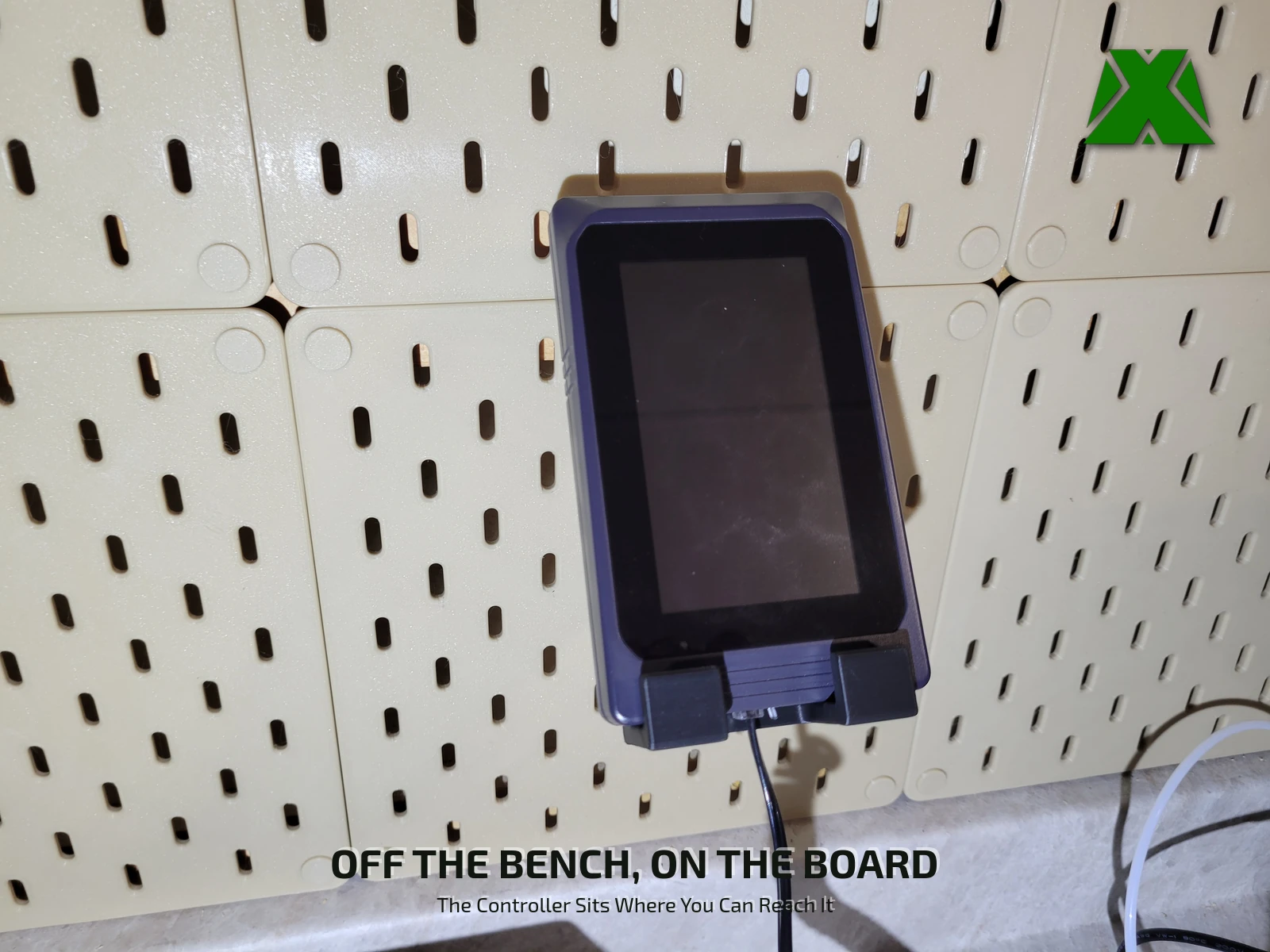 The Neptune 4 Max touchscreen controller sitting in the mount on the pegboard