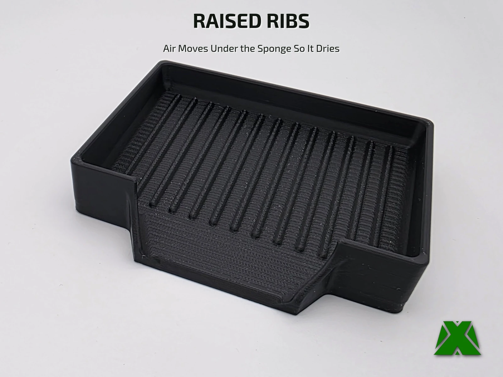 The empty black tray from the front, showing the raised ribs across the floor and the drain mouth cut into the front wall