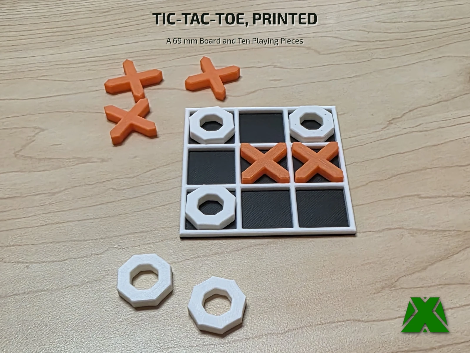 A part-played tic-tac-toe board on a maple desk with two spare X and two spare O pieces beside it