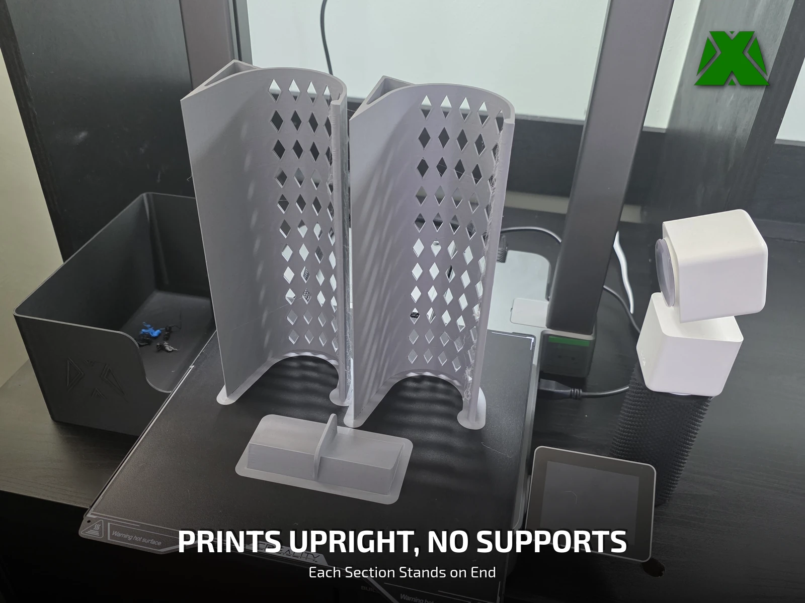 Two toy blocker sections standing on end on the printer's build plate with a connector in front of them