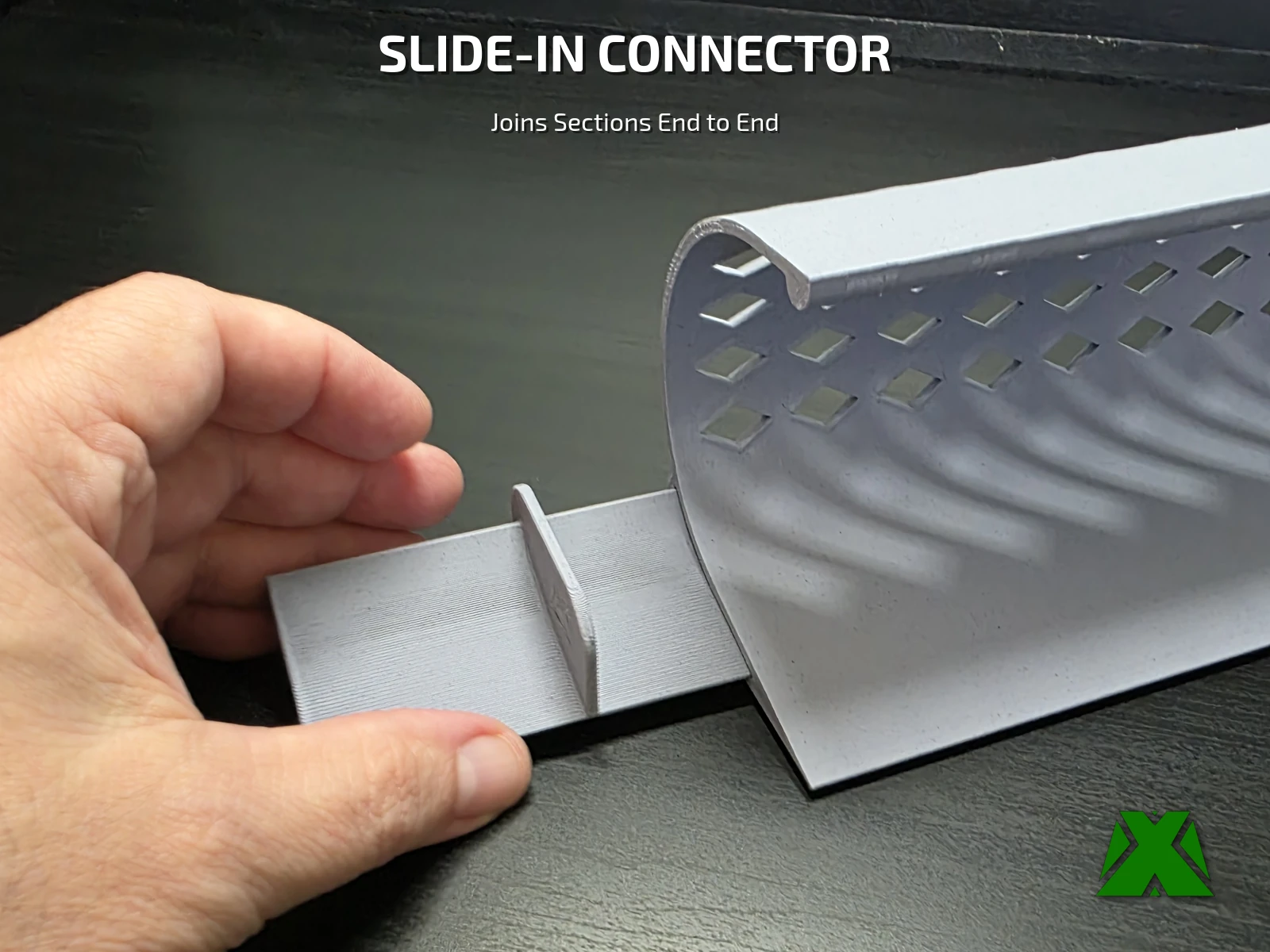 A hand sliding the connector into the bottom of one toy blocker section
