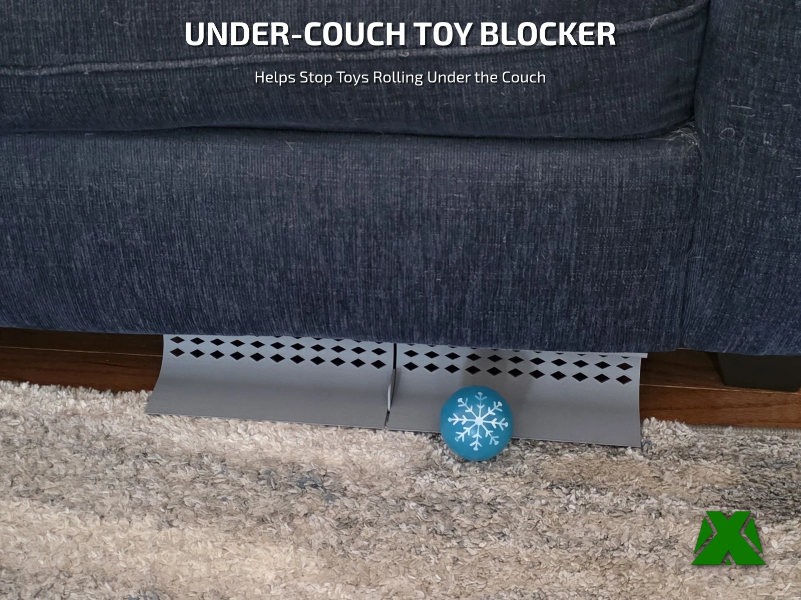 Two gray vented toy blocker sections under the front edge of a blue couch, with a blue dog ball stopped against them on the rug