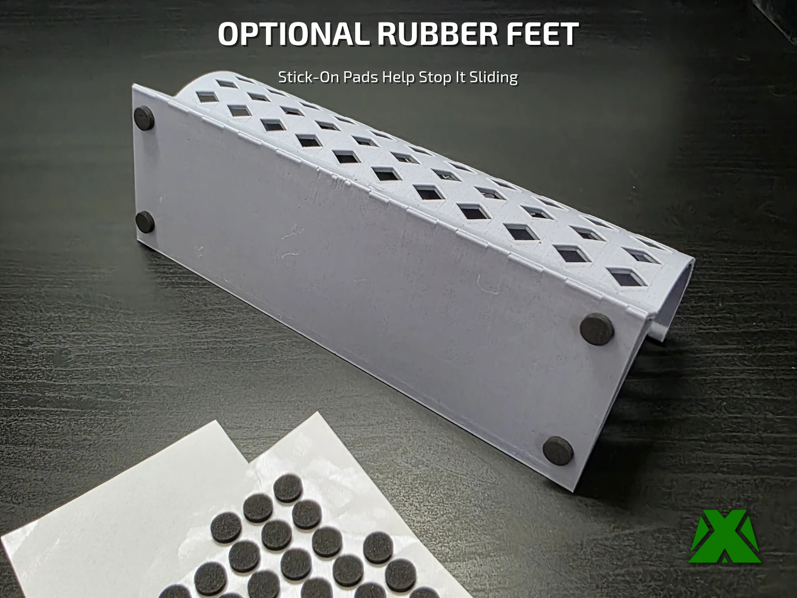 The underside of a toy blocker section with a stick-on rubber foot at each corner, beside the sheet the feet came from