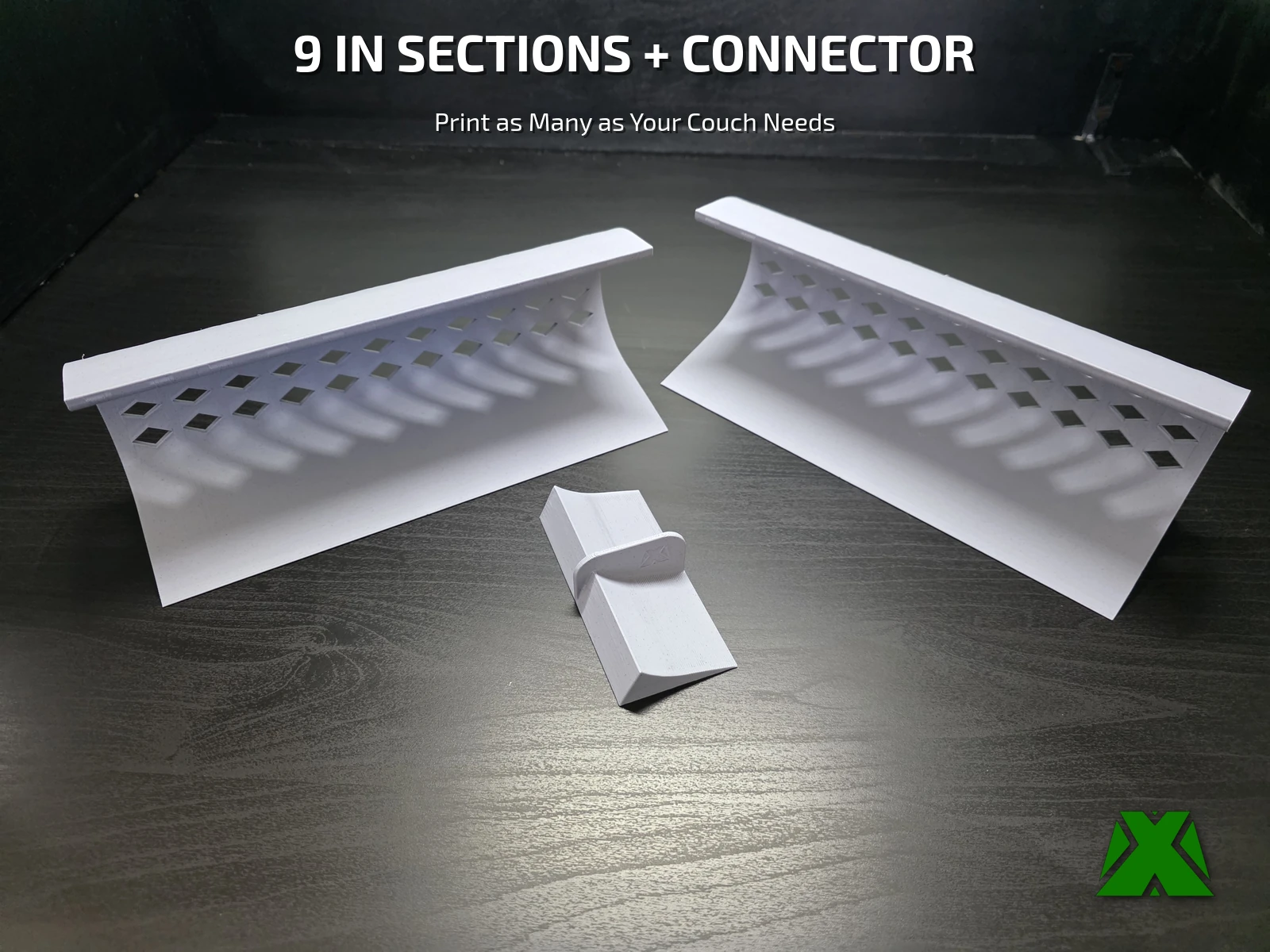 Two toy blocker sections and a connector lying on a black desk