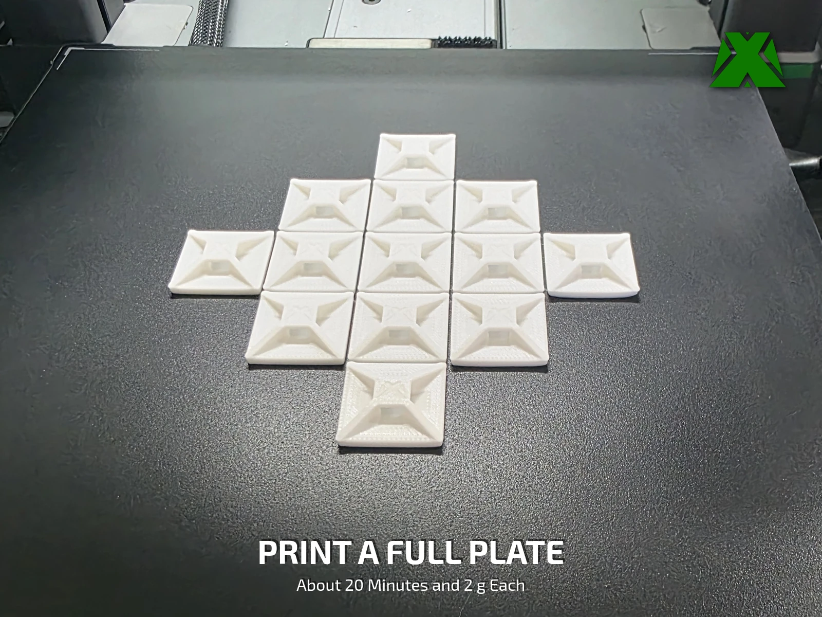 Fourteen white clips printed together on a black build plate