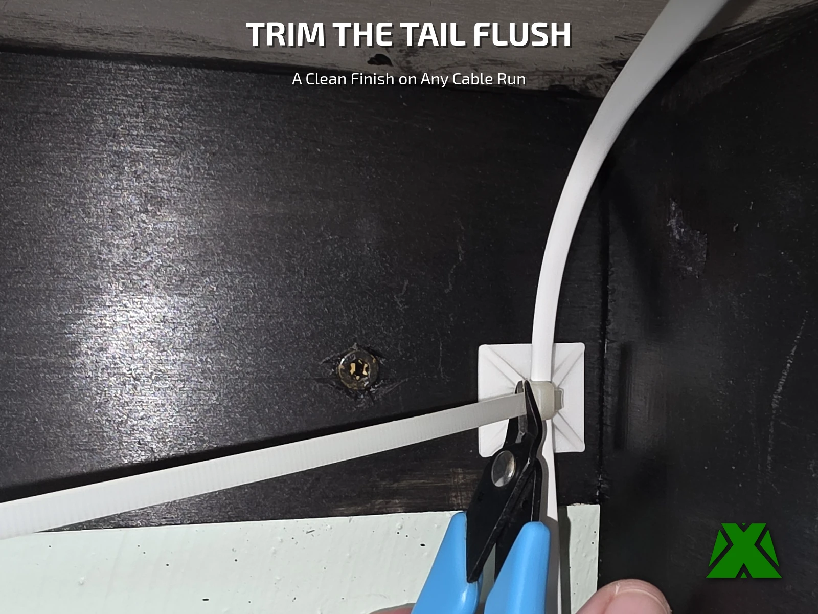 Blue flush cutters trimming the tail of a zip tie right at the clip